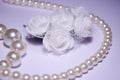 White roses from foamiran and snow-white pearls. Jewelry made of pearls and white roses. Luxury and nobility