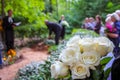 White roses at funeral near the grave