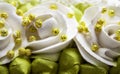 White roses and green leaves made with cream, closeup Royalty Free Stock Photo