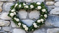 White roses heart shaped arrangement on stone wall Royalty Free Stock Photo