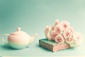 White roses over book and teapot Royalty Free Stock Photo