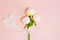 White roses with ribbon over the pink background.