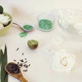 White roses in water, petals, green fruits, sea salt, green tea on a light table Royalty Free Stock Photo