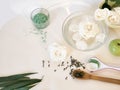 White roses in water, petals, green fruits, sea salt, green tea on a light table Royalty Free Stock Photo