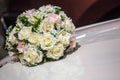 White roses on wedding car hood