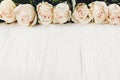 White roses on wooden background, copy space for text. Floral gr Royalty Free Stock Photo