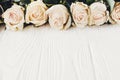 White roses on wooden background, copy space for text. Floral gr Royalty Free Stock Photo