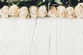 White roses on wooden background, copy space for text. Floral gr Royalty Free Stock Photo