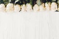 White roses on wooden background, flat lay with space for text. Royalty Free Stock Photo