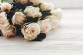 White roses on wooden background, space for text. Floral greeting card mockup. Wedding invitation or happy mother day concept. Bo Royalty Free Stock Photo