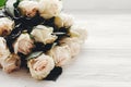 White roses on wooden background, space for text. Floral greeting card mockup. Wedding invitation or happy mother day concept. Bo Royalty Free Stock Photo