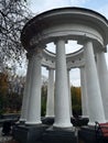 White rotunda with large columns in an autumn park