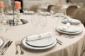 The white round banquet table in the restaurant is decorated with fresh flowers. Stylish event decor Royalty Free Stock Photo