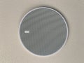 White round ceiling speaker, white plain ceiling Royalty Free Stock Photo