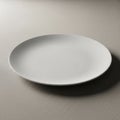 White round ceramic plate is placed on a textured light colored Royalty Free Stock Photo