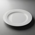 White, round, ceramic plate with a smooth, glossy finish. Positioned against a light Royalty Free Stock Photo