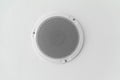 White round circle speaker and grille hanging on ceiling Royalty Free Stock Photo