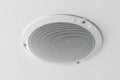 White round circle speaker and grille hanging on ceiling Royalty Free Stock Photo