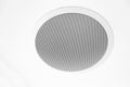 White speaker and grille hanging on white ceiling. Royalty Free Stock Photo