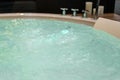 White round jacuzzi with swirling water in the bathroom Royalty Free Stock Photo