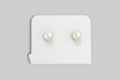 White round pearl earrings for sale mockup isolated on a grey background.