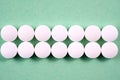 White round pharmaceutical pills on green background