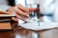 White round pill on tissue and blur hand take a glass of water