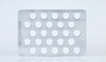 White round pills in blister pack laid on a flat surface Royalty Free Stock Photo