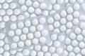 White round pills in packs are scattered on surface. Close-up Royalty Free Stock Photo
