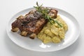 White Round plate with baked pork ribs and cornmeal mush