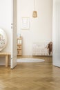 White round rug next to baby`s cradle in bedroom interior with rabbit poster and pillows Royalty Free Stock Photo