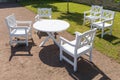 White round table and chairs in garden Royalty Free Stock Photo