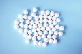 White round tablets, supplements on a blue background. Magnesium vitamins Royalty Free Stock Photo