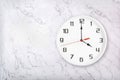 White round wall clock on white natural marble background. Four o`clock Royalty Free Stock Photo