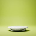 White Rounded Product Display Pedestal with Spring on Green Background