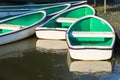 White Rowboats moored at small Pier with Falling Yellow Flowers Royalty Free Stock Photo