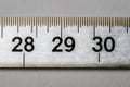 White ruler close-up on grey background Ai photo Royalty Free Stock Photo