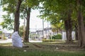 White sacks are used to contain dead leaves that have fallen seasonally in spring as way to clean park and mix leaves to make