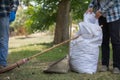 White sacks are used to contain dead leaves that have fallen seasonally in spring as way to clean park and mix leaves to make