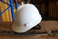 A white safety helmet complete with suspension and chin strap
