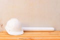 white safety helmet plastic and paper roll plan blueprint construction of engineering on wood floor table background with copy sp Royalty Free Stock Photo