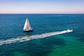 White sail boat isolated in blue sea water. Sailboat in the sea in the sunlight, luxury summer adventure, active vacation in