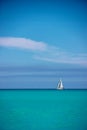 White sailboat against blue sky