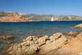 White sailboat along the granite coast of Sardinia