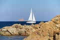 White sailboat along the granite coast of Sardinia