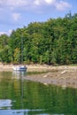 A White Sailboat Moored At The Shore. Sailing A Yacht On Lake Solina In Summer. Panorama Of The Bieszczady Mountains, Poland