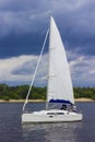 White sailboat sailing on a river