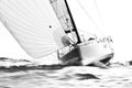 White sailboat with spinnaker on ramming speed