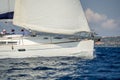 White sailing boat at charter cruise with a crew sitiing on port side. Royalty Free Stock Photo