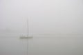 White Sailing Boat in The Fog Royalty Free Stock Photo